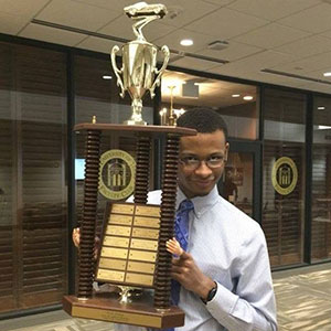 Julian Davis, a chemical and biomolecular engineering major, holds the first-place trophy after a team of Nebraska Engineering students won the Chem-E-Car competition at the AIChE Mid-America Student Regional Conference.