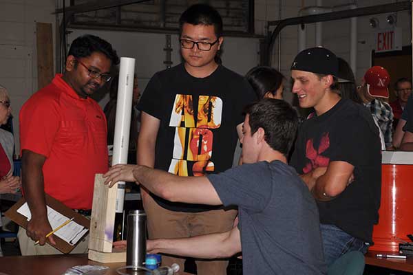 Rapid Design Challenge judge Santosh Pitla, assistant professor of biological systems engineering, discusses the deign of a device with the team of Zachary Duncan, Nicole Schwery, Dillon Soukup and Zhichen Wang.
