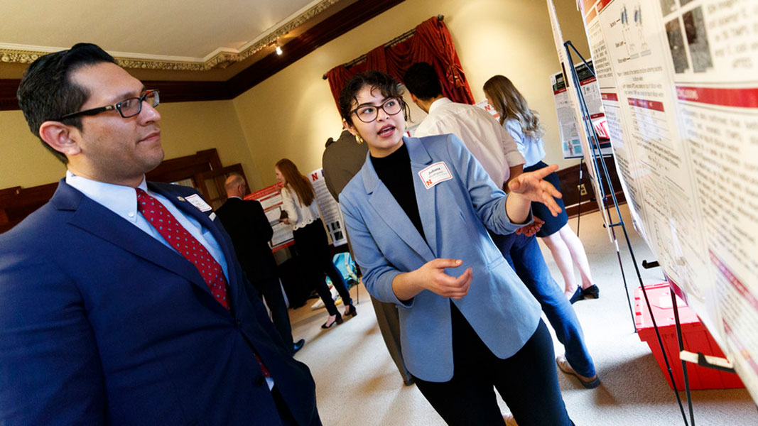 Juliana Rodriguez presenting her antibiotic resistance work at Nebraska Captiol Breakfast Poster Session to Senator Vargas.