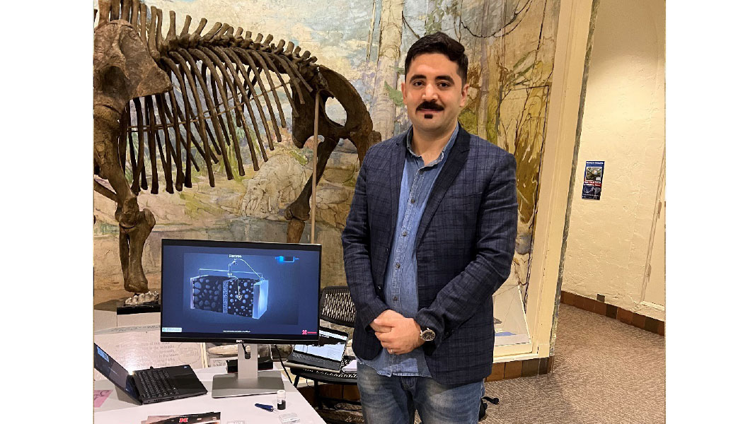 Sahand standing next to his demonstration slide.