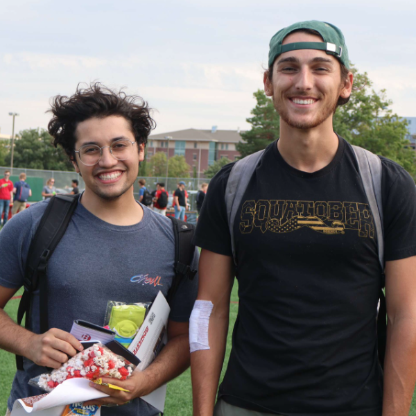 Engineering student holding a college of engineering t-shirt at new student welcome event.