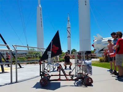 Students taking photos of rockets.