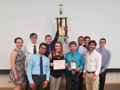 Members of the CHEM-E Team hold the trophy for winning the regional competition.