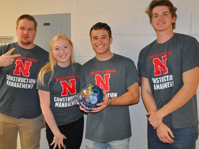 Group of students smile for the camera while bowling.